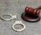 Image of a pair of handcuffs and a gavel on a table on Blackford & Flohr's website