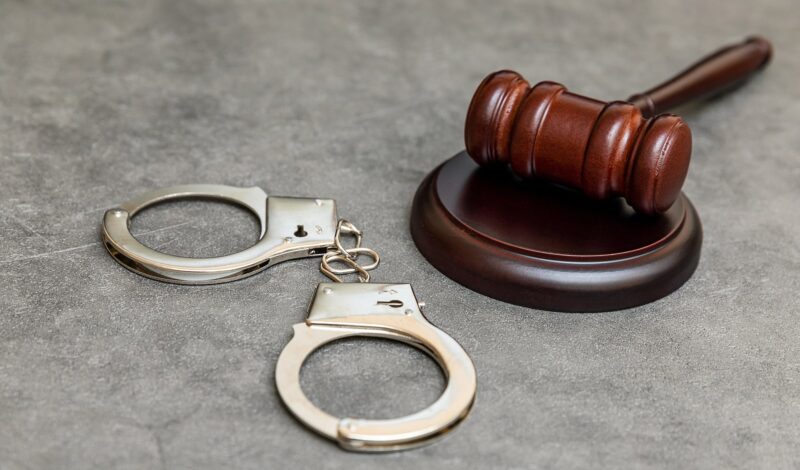 Image of a pair of handcuffs and a gavel on a table on Blackford & Flohr's website