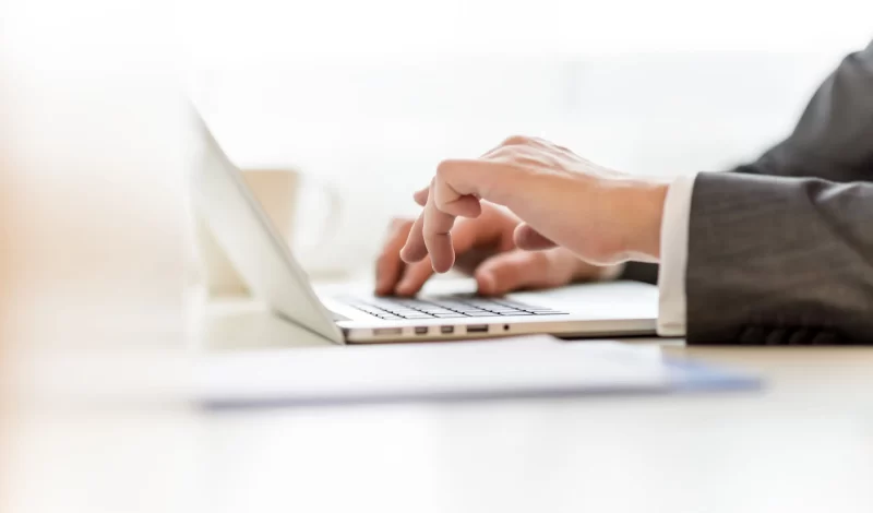 A person typing on a computer
