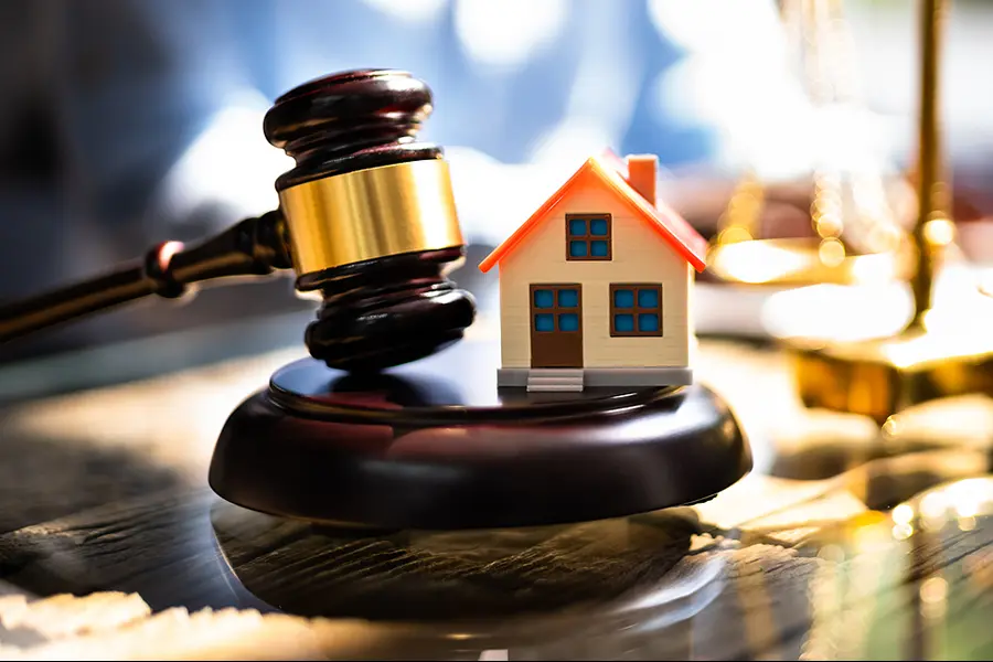 A gavel and a miniature of a house