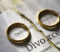 Image of two rings on a piece of paper with the word Divorce printed on it